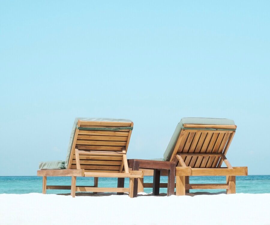 two brown wooden outdoor chaise loungers on beach get smart with money